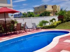 Cardamon Villa is a 2 bedroom with 1 bathroom and seperate toilet detached house with AC and swimming pool , 5 minutes walk from Flic en Flac public beach