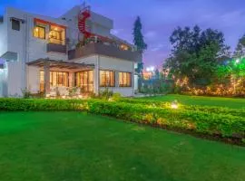 StayVista's Fairfield Villa - A green lawn and charming orchard await your retreat