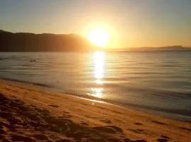 Pé na areia, casa na praia de frente para o mar