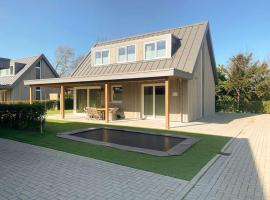 Villa Maroma Regal Veerse Meer 4 E-bikes, gratis laden EV, trampoline, Hotel in Kamperland