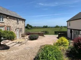 The Granary at Pentregaer Ucha, tennis court & lake.