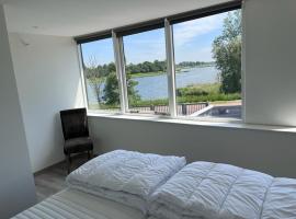 Comfortabele woning mét omheinde tuin aan water voor 12 p, hotel near Brugse Vaart Golfbaan, Oostburg