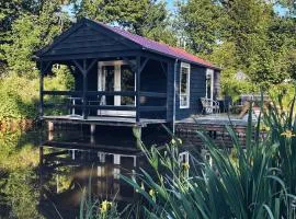 Kampeerhuisje met veranda over de vijver