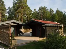 Timber cottages with jacuzzi and sauna near lake Vänern