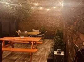 1850s historic Row House 7min train to NYC with private backyard