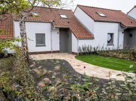 'A little white house with a tree by the sea' with beach cabin by BLOSS