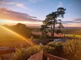 Our beautiful large Suite room with a Double bath with Shower ensuite - It has a full Kitchen boasting stunning views over the Axe Valley - Only 3 miles from Lyme Regis, River Cottage HQ & Charmouth - Comes with free private parking