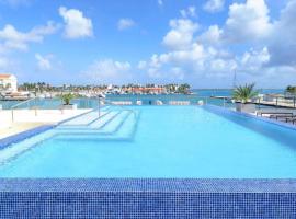 Stylish luxury condo, central location, ocean view, pool, gym, alojamiento en Oranjestad