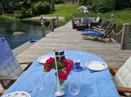 Timber house with private beach and boat including.