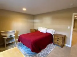 Private basement bedroom with private bathroom, kitchen, and living room with large screen television