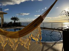 Luxury villa with private heated pool, garden and views of the sea and mountains., hotel in Arco da Calheta