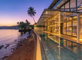 Oceanic Sunsets with River View, Comp Breakfast & Infinity Pool at StayVista