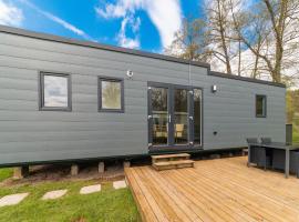 Brand new spacious mobile home with private terrace, next to a babbling brook, glamping site in Érezée
