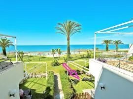 On Beach Deluxe Apartment with Pools and own Garden