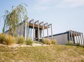 Chalet with a view of the beach or harbour, in a holiday park on the Leukermeer