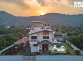 StayVista's Kaarma Villa - Valley-View Villa with Outdoor Pool, Lawn featuring a Gazebo & Machan