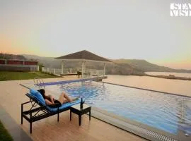 StayVista's The Aquamarine Villa - Igatpuri - Lakeside Retreat with Infinity Pool & Deck, Theatre Room & Gazebo