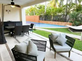 Relax, with our beautiful gardens, large pool and just steps from the beach and lagoon