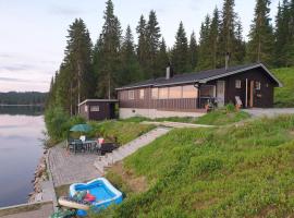 Idyllic lakeside cabin with private beach and boat, cabin in Vassli