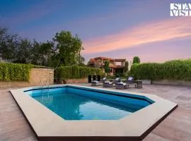 StayVista at The Cityscape with Lawn & Pool