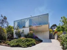 Architectural glass house with ocean views
