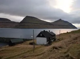 House by the ocean and majestic mountains