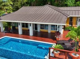 Relax At This Hillside Retreat That Overlooks The Lush Forest And The Caribbean,