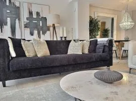 Experience luxury in this stunning three-bedroom modern townhouse frontline to the San Roque Golf