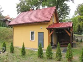 Cottage with fireplace, right on the lake, Ryn