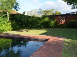 Retro Red Stone Villa with pool & lush garden