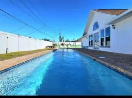 Walk to waves Beautiful 3-Bedroom with pool steps from beach