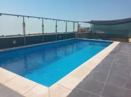 Shared cauchi corner house with roof top pool and pay per use aircondition