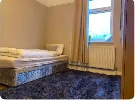 Large room with single bed, work desk and double wardrobe