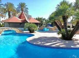 3 minutes from the beach with swimming pools, slides, and a bar