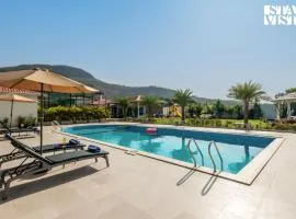 StayVista at The Grand Ten with lawn and pool