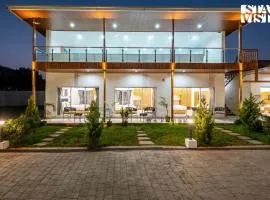 StayVista at The Grand Ten with lawn and pool