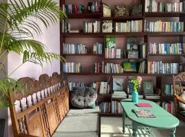 Here Library - A wooden home by the river with a library