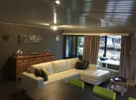 Modern chalet in a small park with a fishing pond