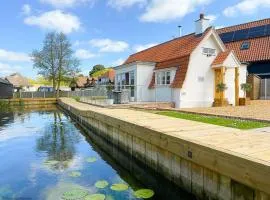 Dutch Cottage sits in its own basin off the River Bure in Horning