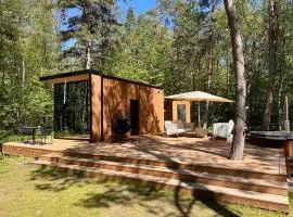 Telise TinyOne is a modern forest cabin with a cozy hot tub