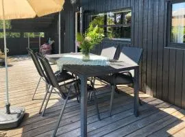Black Wooden Cottage Near Forest And Beach