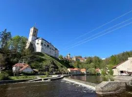 A room by a weir with a view of Rožmberk Castle