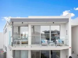 Relax in blissful sun-soaked luxury by the beach