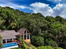 Relax At This Hillside Retreat That Overlooks The Lush Forest And The Caribbean,