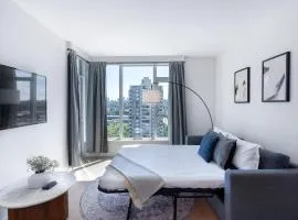 Highrise Condo with AC, Balcony and City Views near SkyTrain for 4