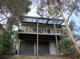 Holiday house among native trees overlooking wetlands