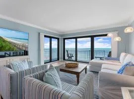 Updated direct oceanfront corner with a wrap-around balcony, heated pool and beach access
