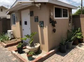 A small room in the backyard with a full bed