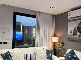 A cozy two-bedroom apartment with a living room and a patio that inspires relaxation