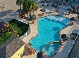 Shared Resort-Style Pool Playground Patio w Bar Tidal Times by AvantStay
